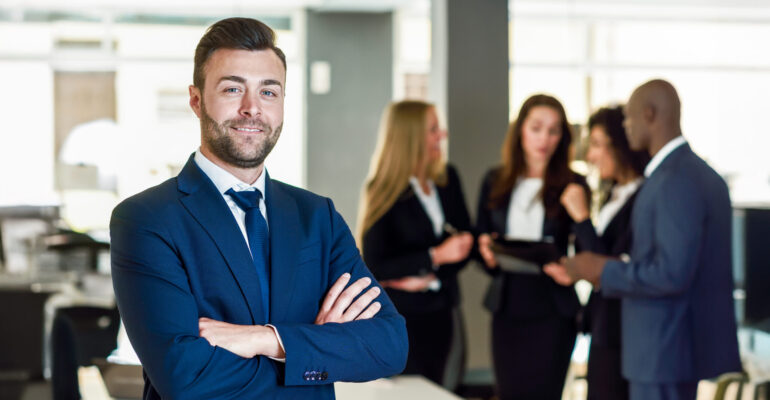 Businessman leader in modern office with businesspeople working